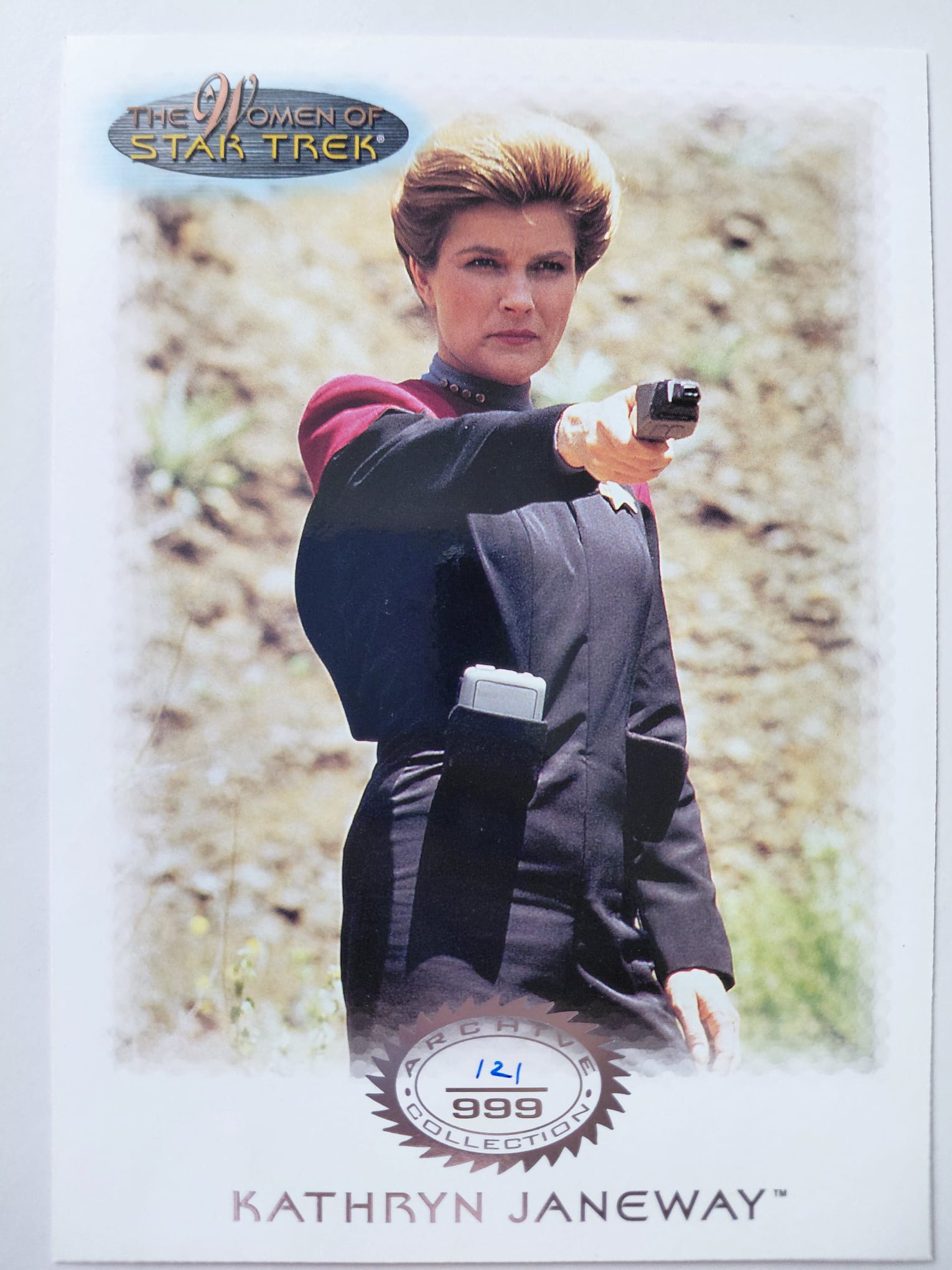 Trading card featuring Kathryn Janeway from Star Trek with a blurred natural background